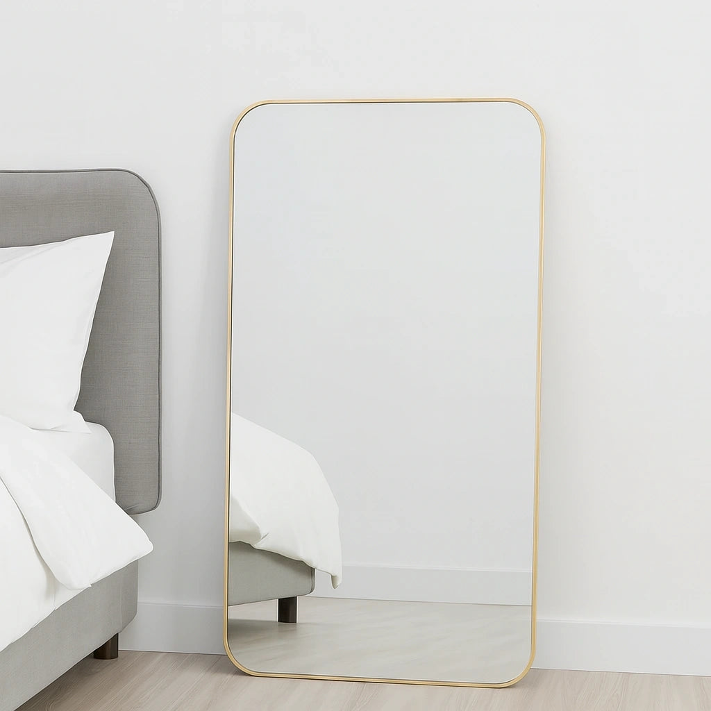 Elegant brass full-length mirror with an unlacquered brass frame, showcasing refined craftsmanship and modern minimalist design