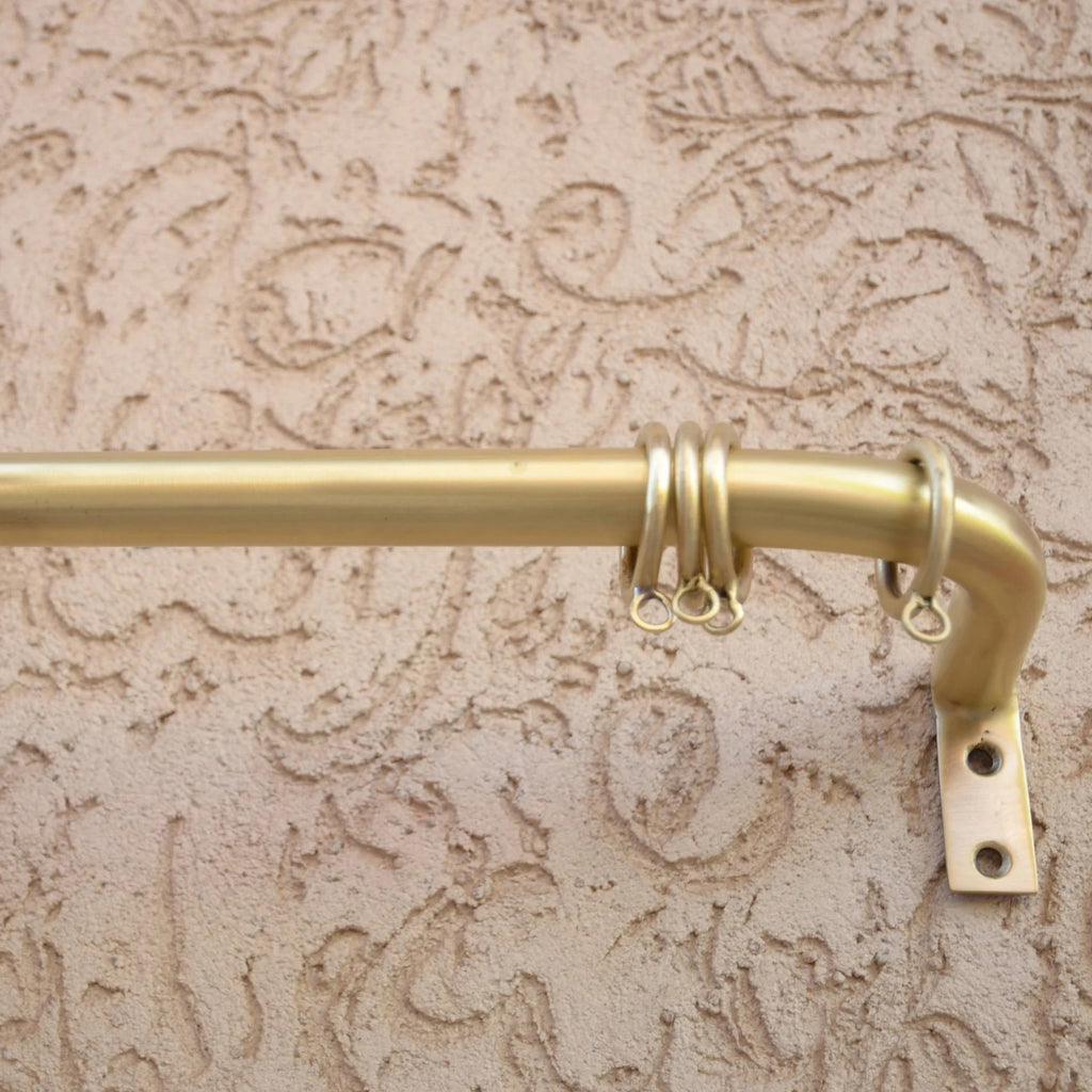 Wall-mounted unlacquered brass curtain rod with rings for modern window styling – Atlas Finest hardware