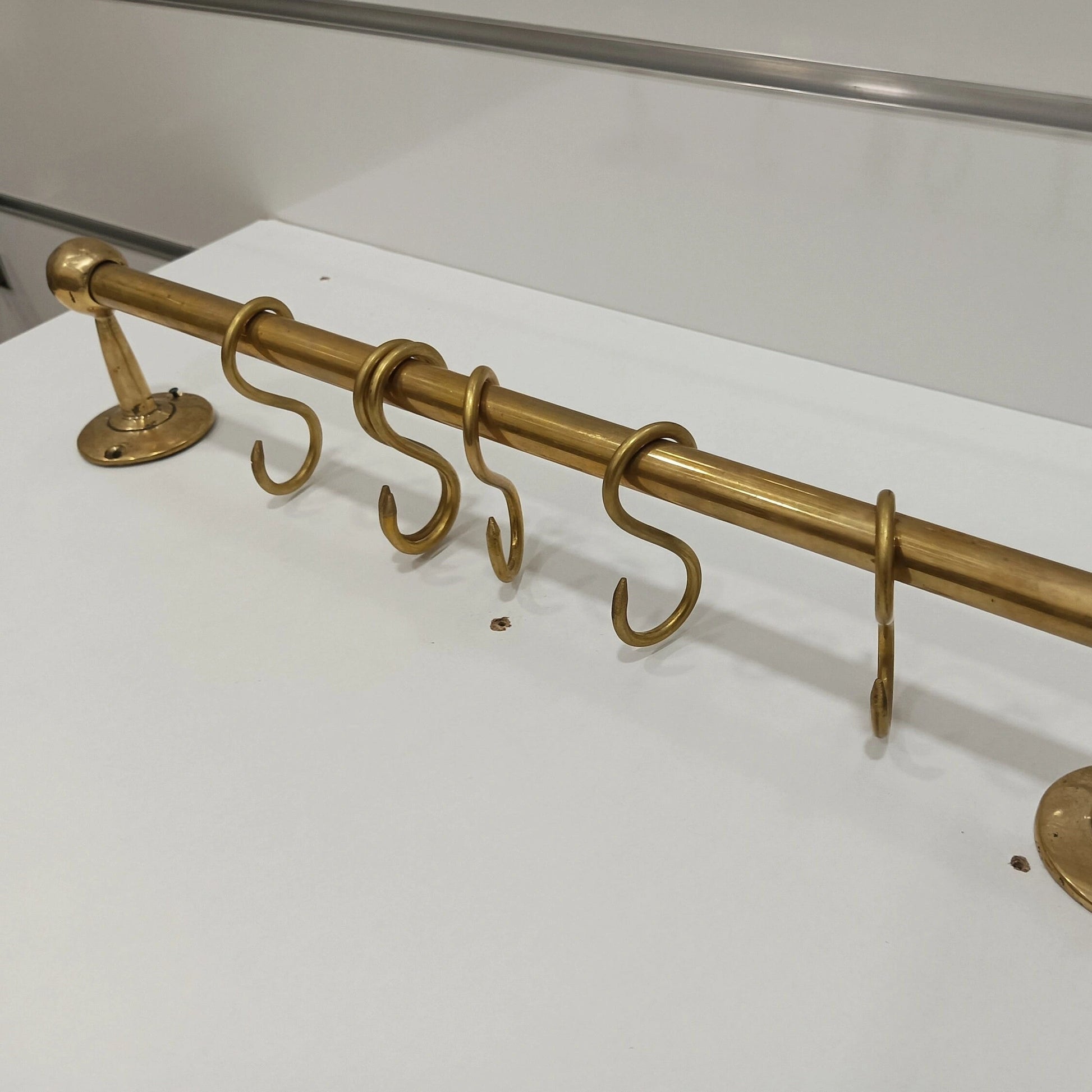 Unlacquered brass wall-mounted kitchen rod with S-hooks, handcrafted design for hanging utensils and accessories – Atlas Finest premium brass hardware