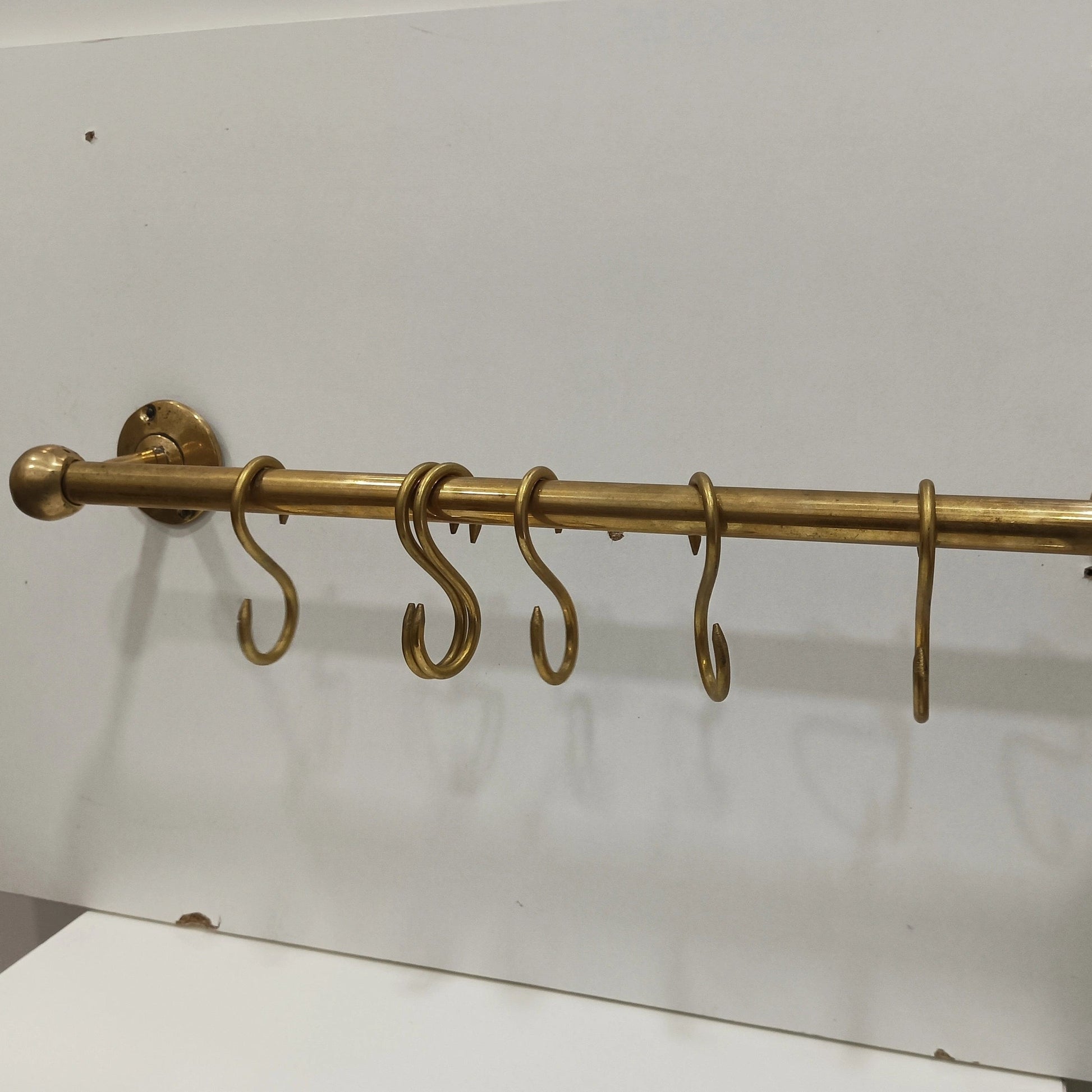 Handcrafted unlacquered brass wall-mounted kitchen rod with S-hooks – Atlas Finest premium brass hardware