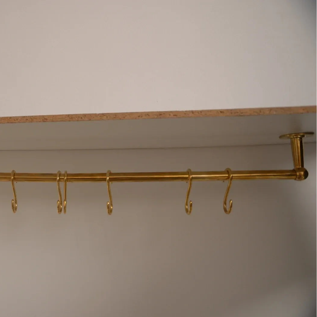 Long ceiling-mounted unlacquered brass kitchen rod with multiple S-hooks for utensils – Atlas Finest