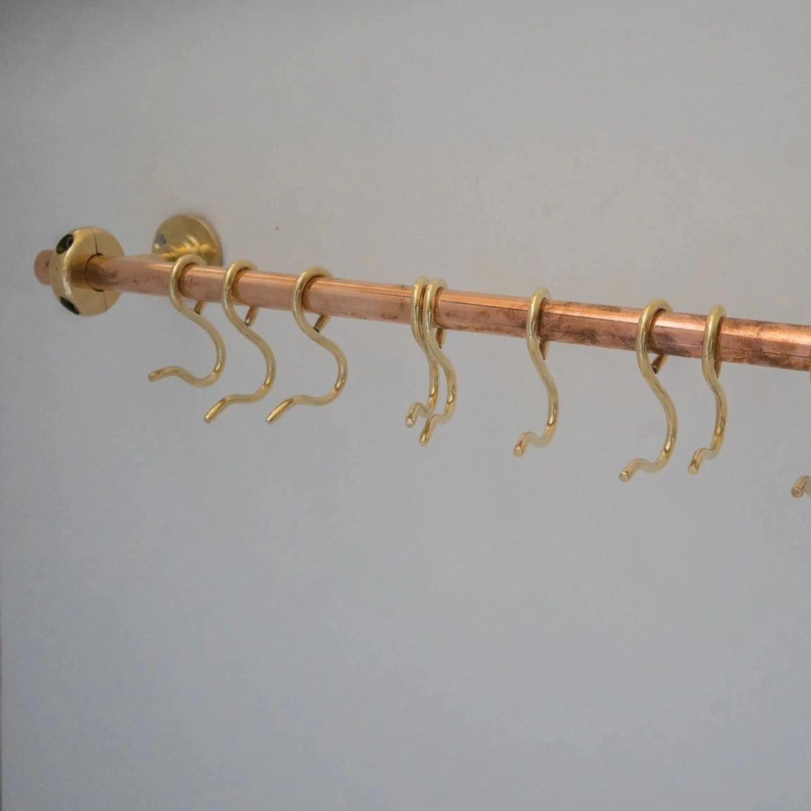 Unlacquered brass and copper wall-mounted kitchen rod with S-hooks for utensils – Atlas Finest