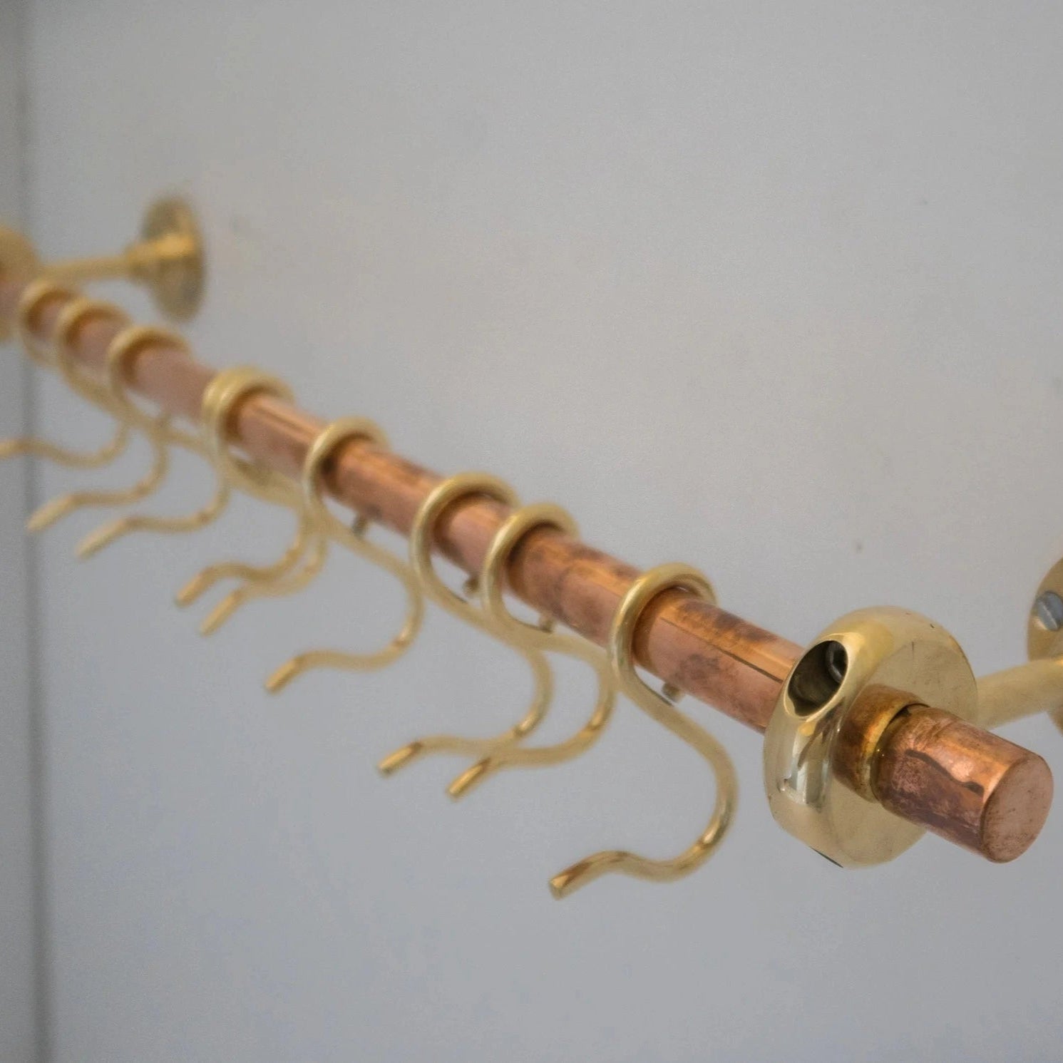 Unlacquered brass and copper wall-mounted kitchen rod with hooks for utensils – Atlas Finest