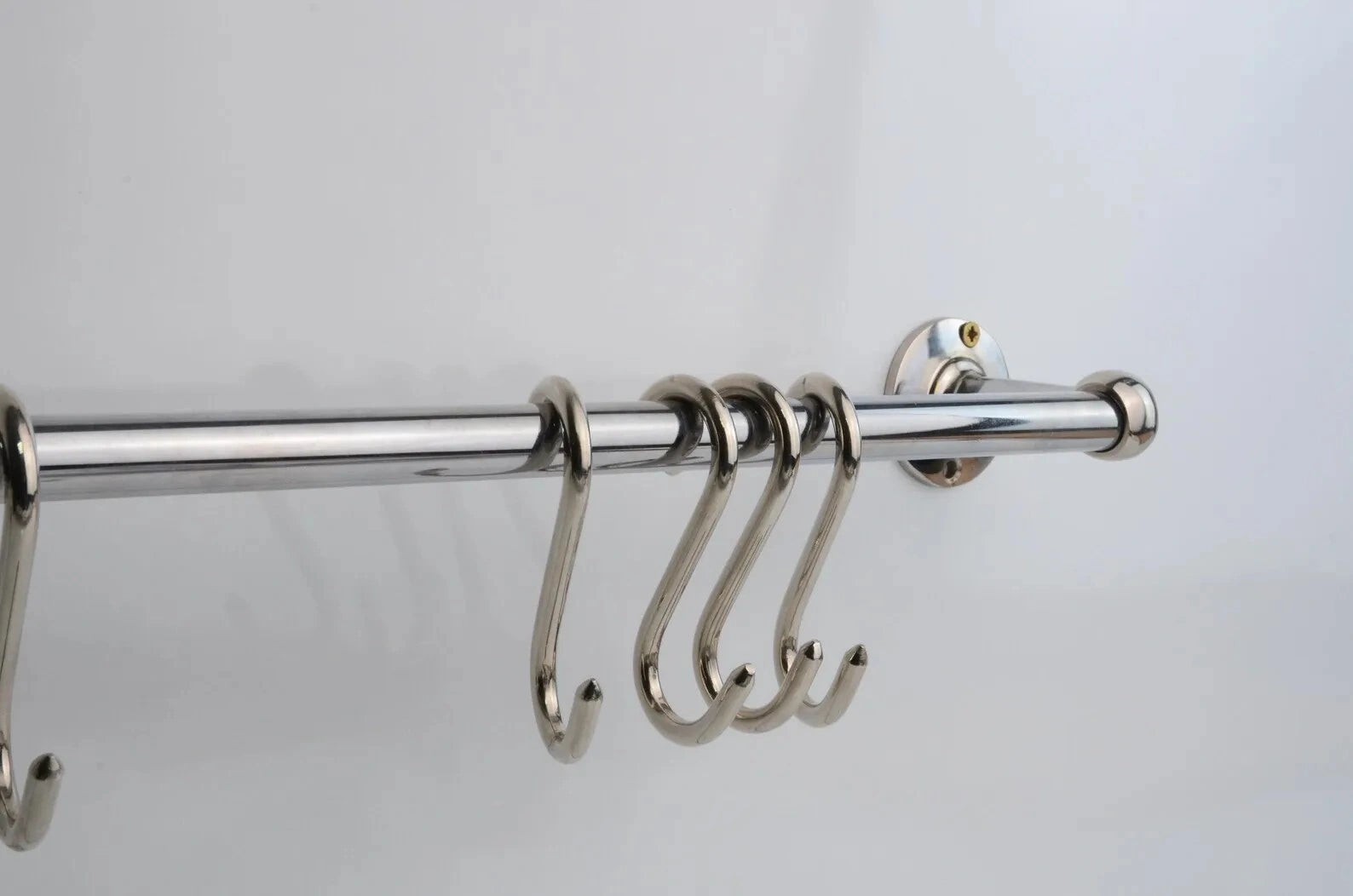 Luxury solid brass pot rack in polished chrome finish, wall-mounted rail with four hanging hooks, perfect for kitchen organization and storage