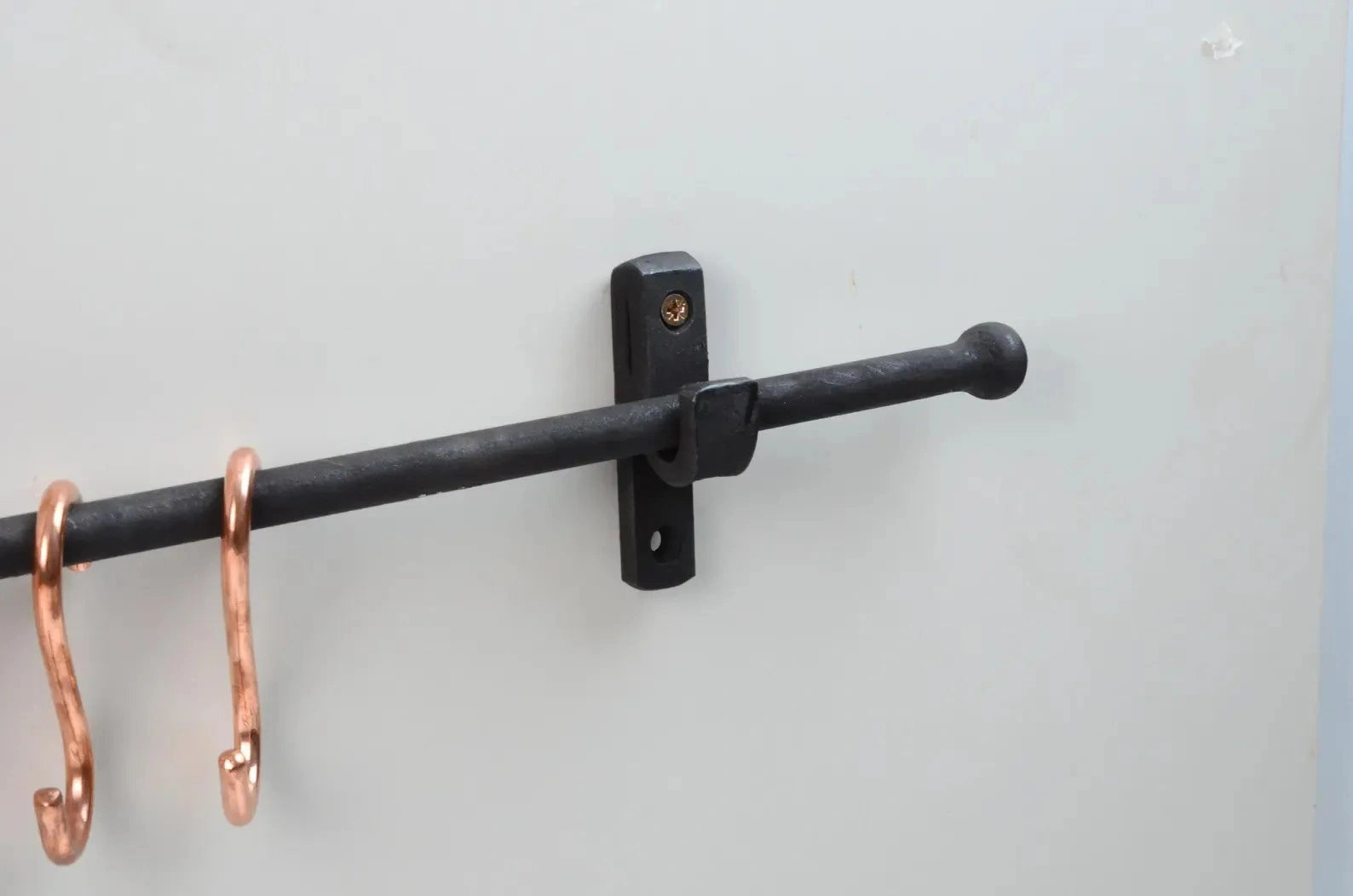 Durable black iron pot rail featuring copper S-hooks for efficient kitchen organization – Atlas Finest