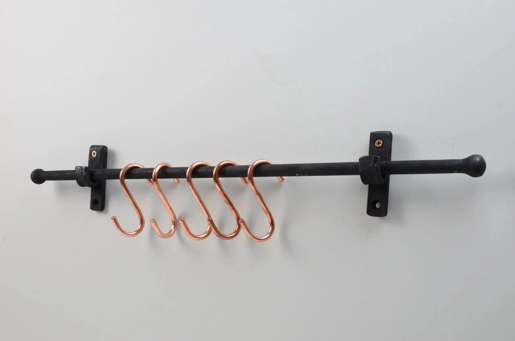Handcrafted wall-mounted iron rail with copper hooks for organizing kitchen utensils – Atlas Finest
