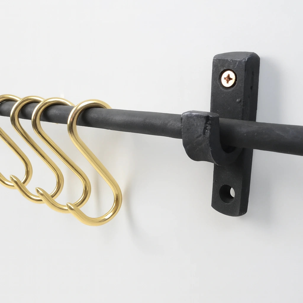 Handcrafted black iron pot rail with brass S-hooks for elegant kitchen storage – Atlas Finest
