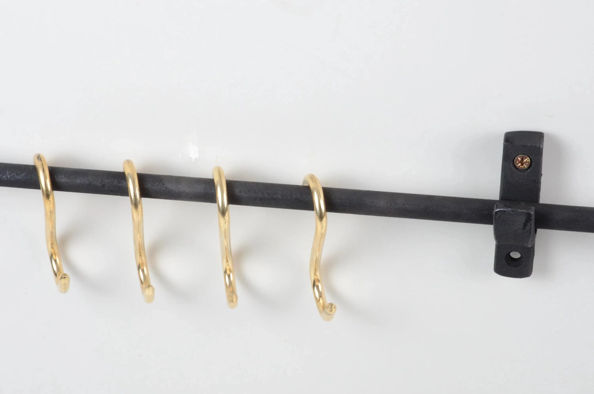Rustic black iron pot rail featuring brass S-hooks for decorative kitchen organization – Atlas Finest