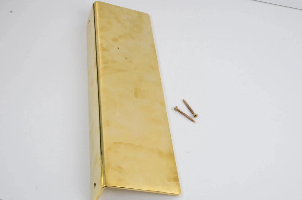 Long unlacquered brass floating shelf with installation screws on white background, showcasing polished golden finish and elegant craftsmanship-atlas finest