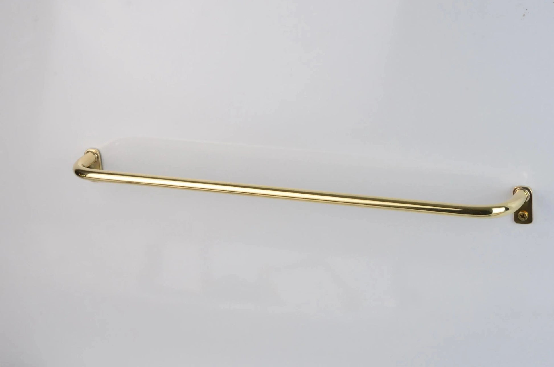 Minimalist brass café drapery rod with curved French return ends, wall-mounted