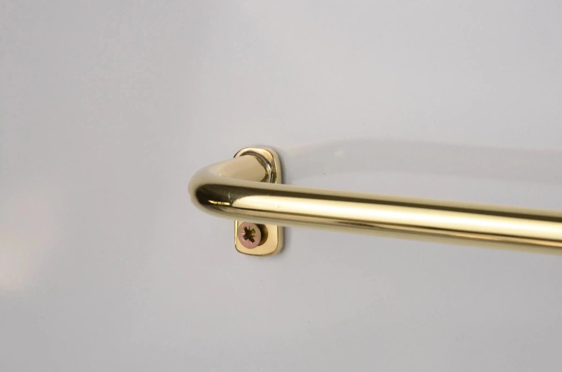 unlacquered brass café drapery rod with curved French return brackets