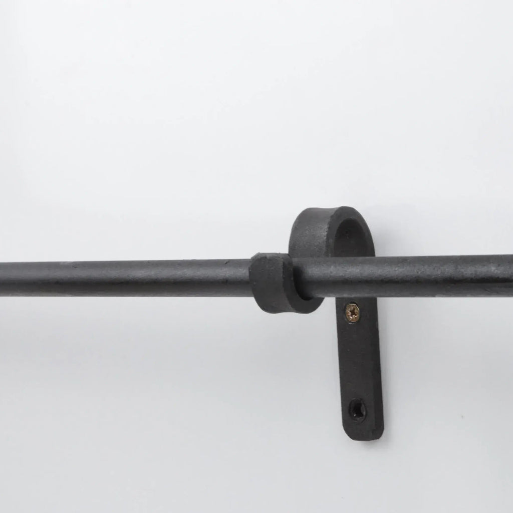 Minimalist black iron curtain pole mounted on wall