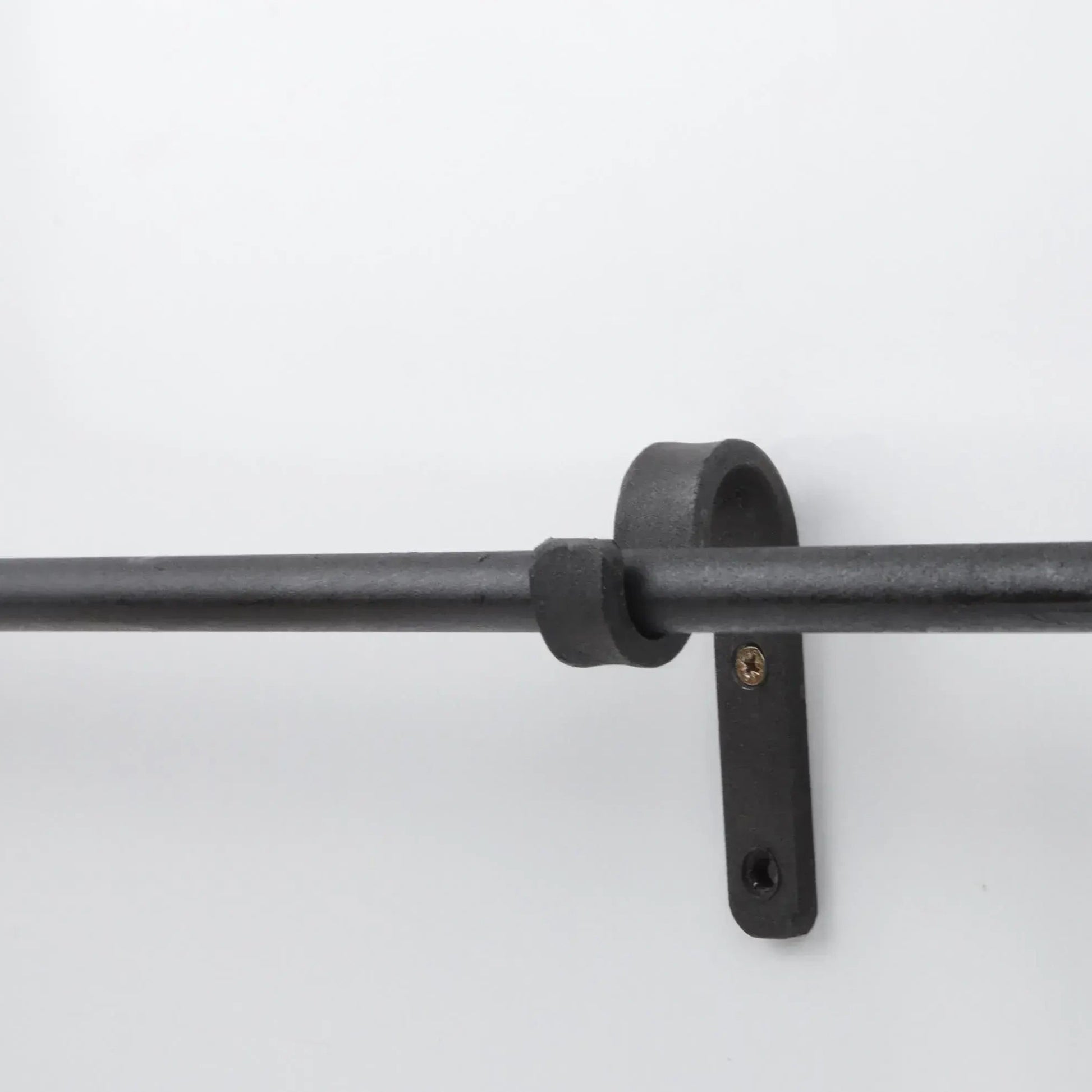 Minimalist black iron curtain pole mounted on wall