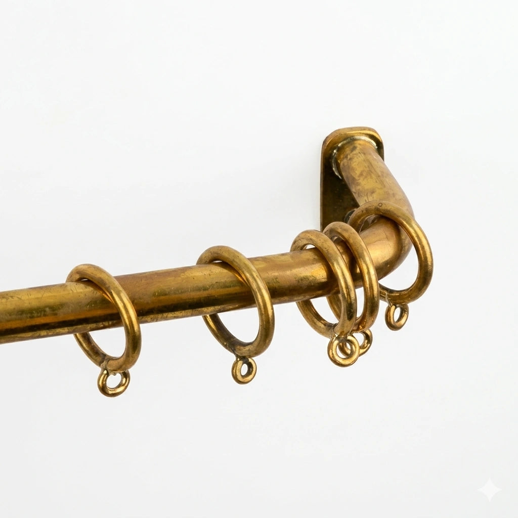 agedcurtain rod with rings on a white background