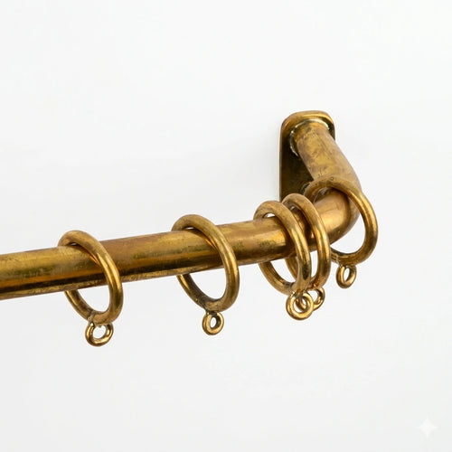agedcurtain rod with rings on a white background