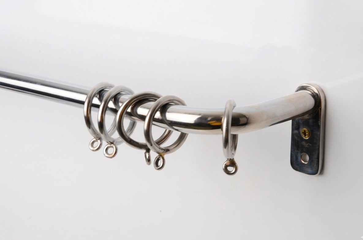 brass curtain rod with rings on a white background