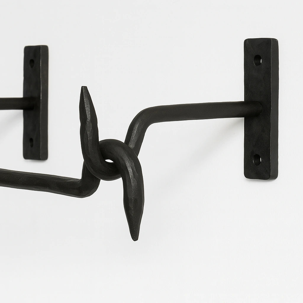Close-up of black forged iron wall-mounted pot rack bracket  – Atlas Finest