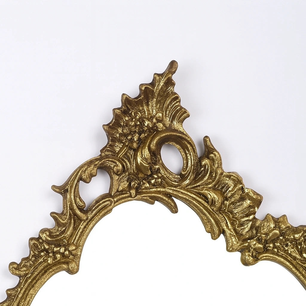 Close-up of Victorian brass mirror frame showcasing detailed craftsmanship in unlacquered brass finish